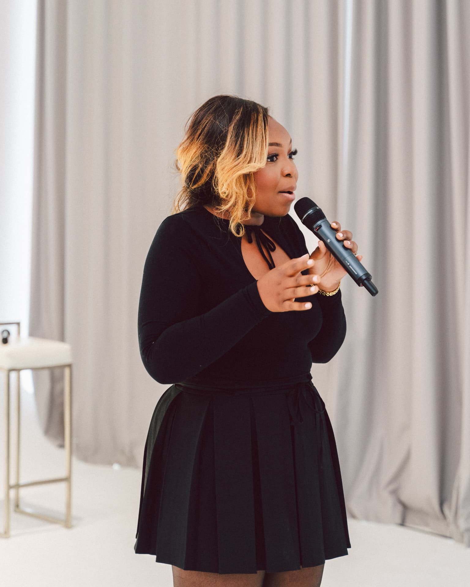 Speaker addressing the room with a microphone